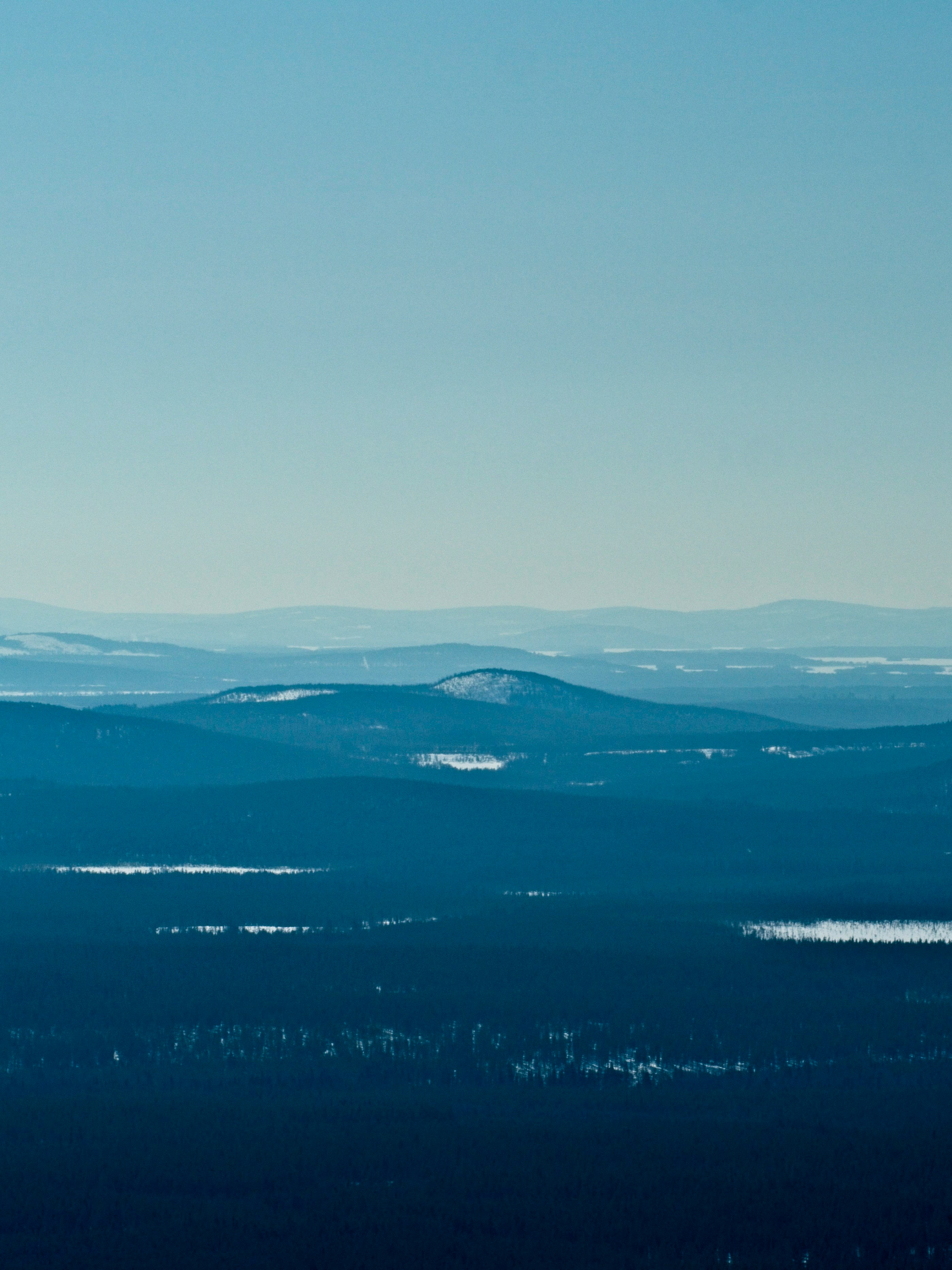 blue and white sky over mountains